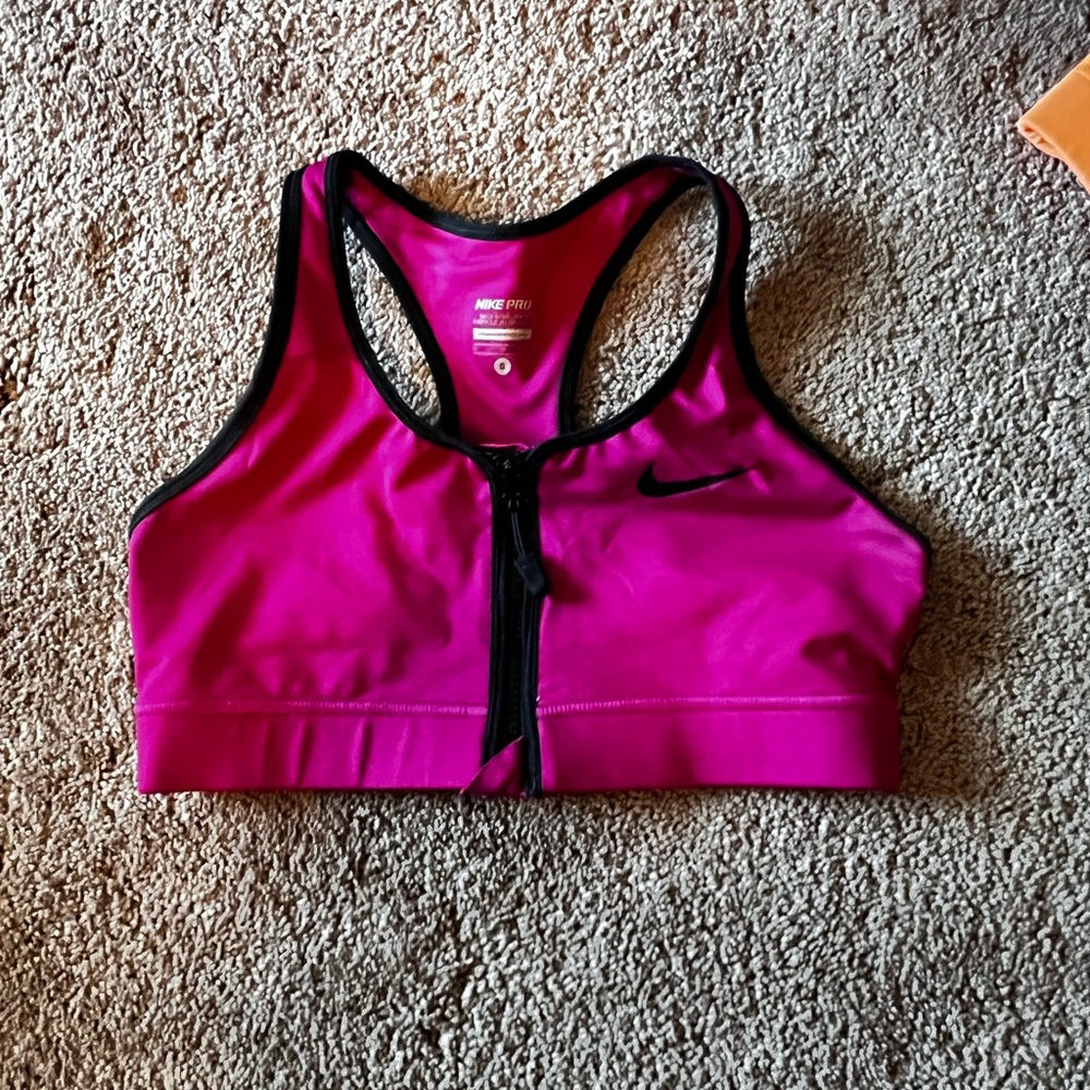 Nike Pro Sports Bra. Size small. Front zip. Racerback. Neon raspberry.
Dri-Fit
